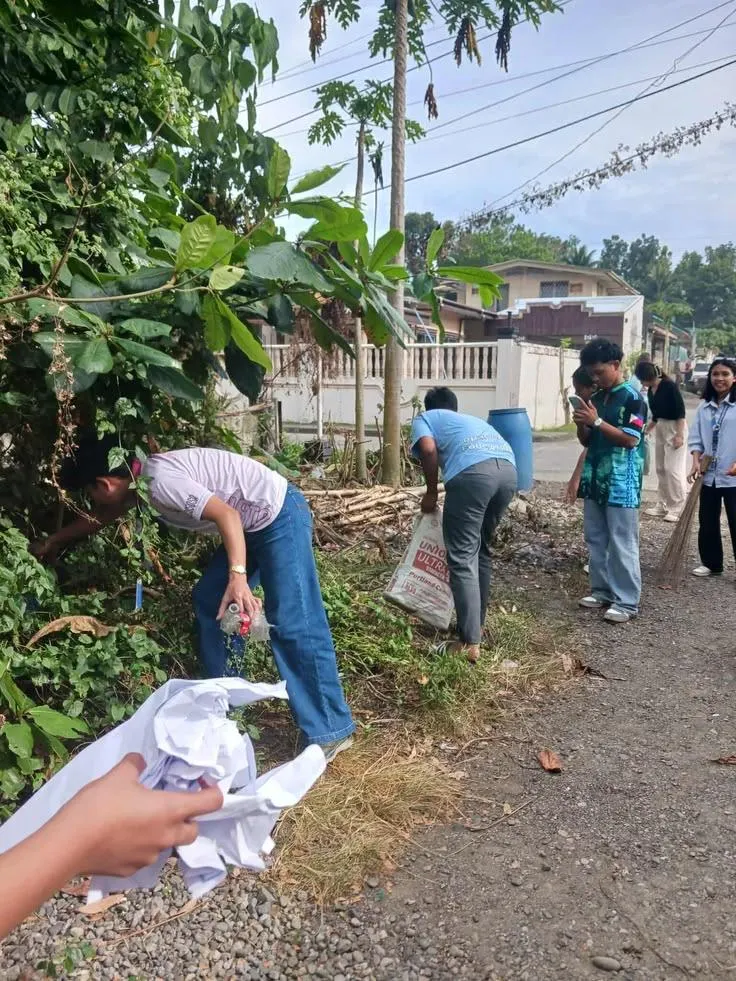 Community volunteers picking up waste and cleaning a neighbourhood street