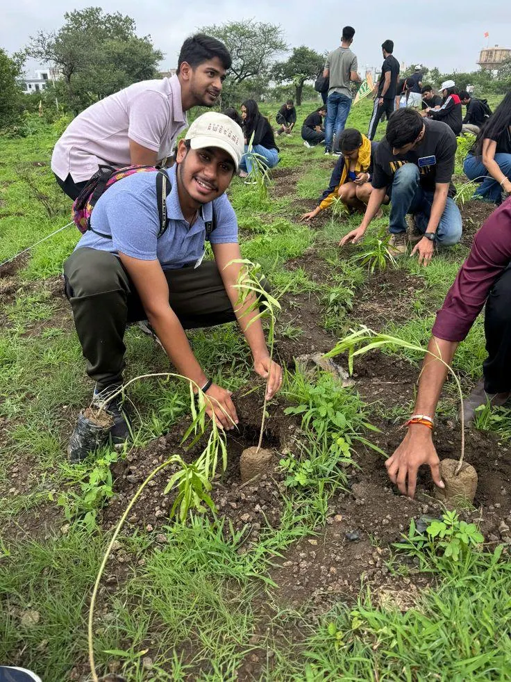 Young volunteers planting saplings during a group-organised tree plantation drive