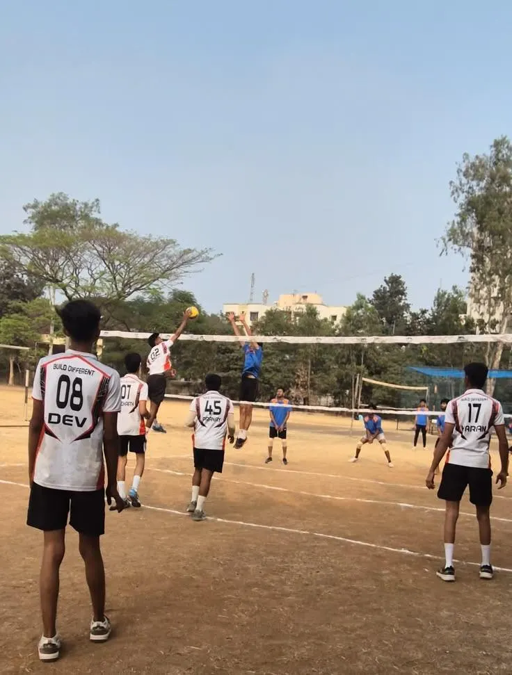 Volleyball match in action during an inter-district tournament with players wearing DEV jerseys