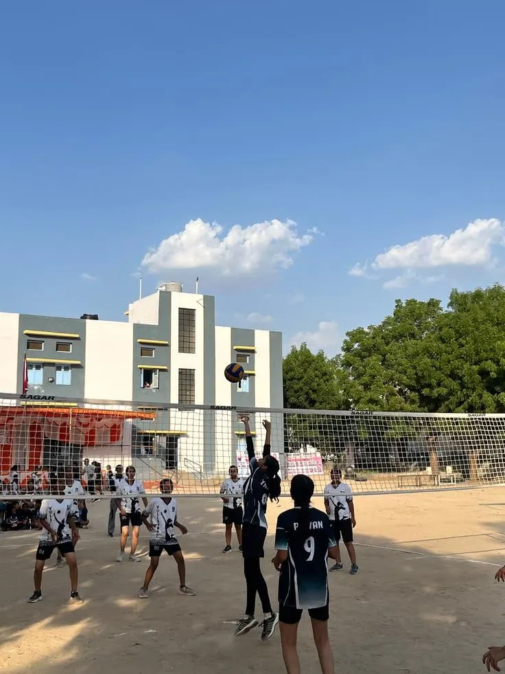 Volleyball players jumping at the net in a community tournament